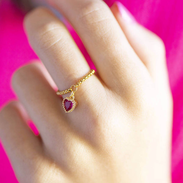 Image shows model wearing chain slider ring with July heart birthstone charm