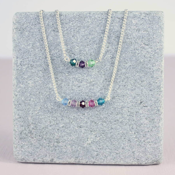 Image shows two family birthstone bar necklace