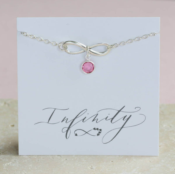 Image shows silver Infinity Birthstone Charm Bracelet on a friend sentiment card