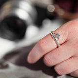 Image shows model wearing silver pave star beaded charm ring 