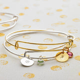 Image shows silver and gold personalised birthstone bangles 