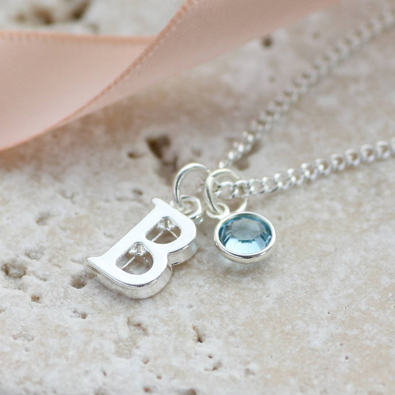 Image shows personalised birthstone charm necklace with initials and march birthstone