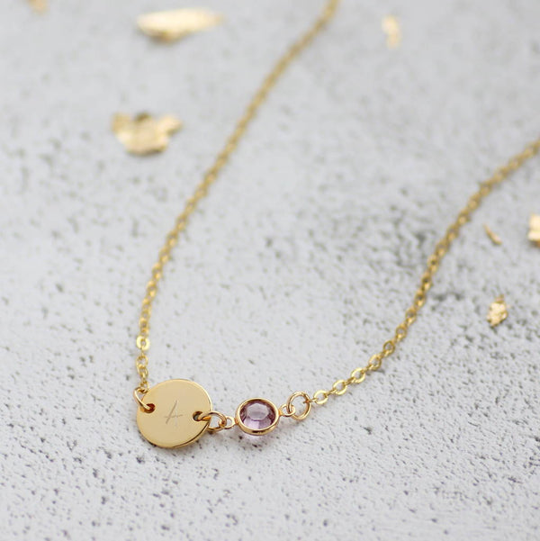 Image shows personalised gold disc birthstone necklace with A initial on disc and June birthstone