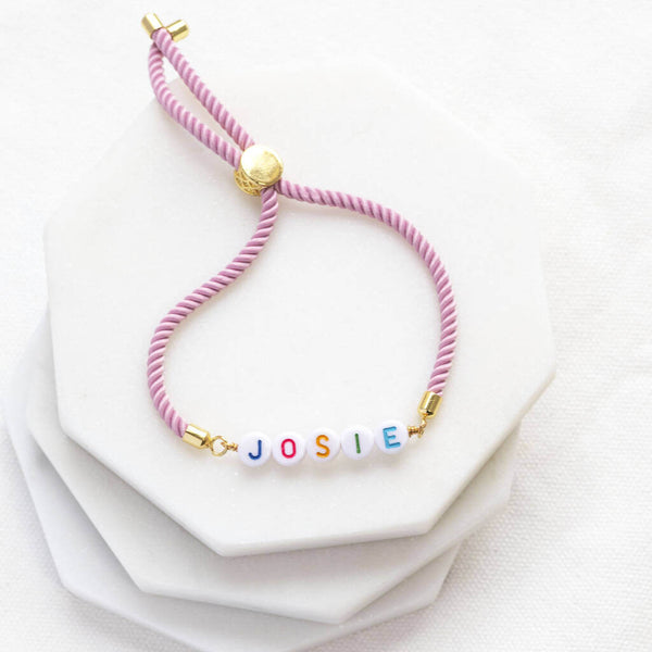 Images shows Pink Custom Name Friendship Bracelet with the name Josie