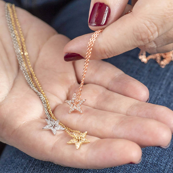 Image shows model holding Silver,Gold and rose gold Sparkle Star Threader Necklace