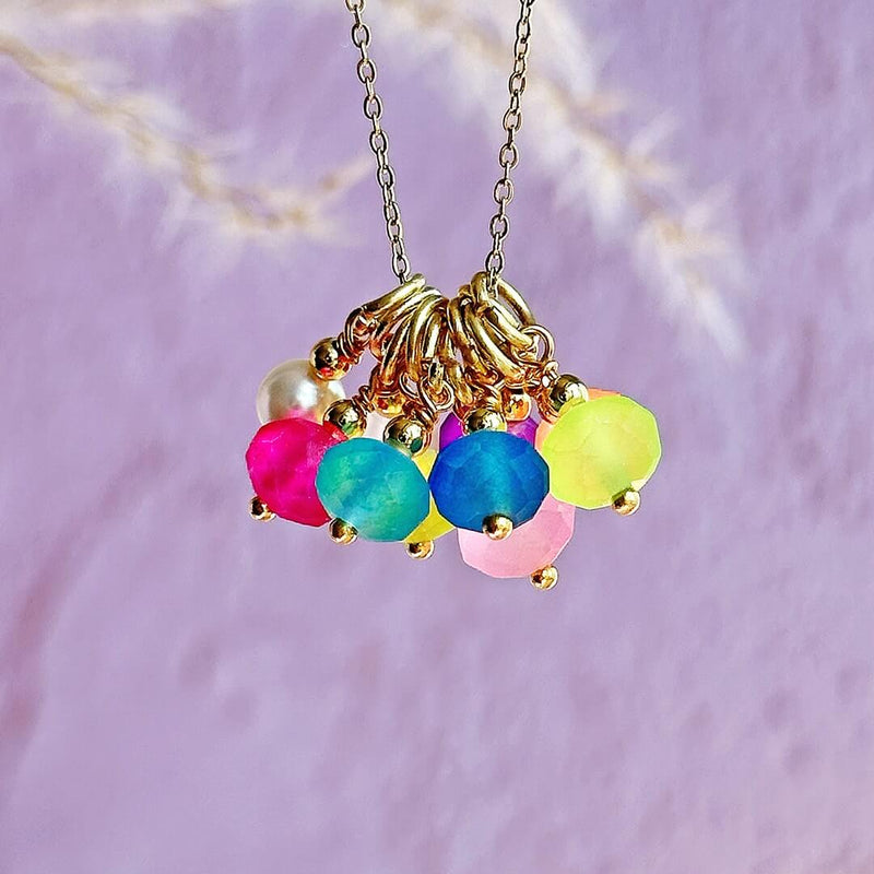 mage shows Summer Essential Multiwear Bright Charm Necklace hanging against a blurred background