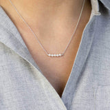 model wears silver delicate Swarovski pearl necklace 