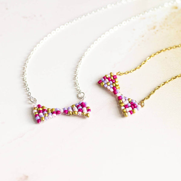 From left to right image shows: silver plated Beaded Bow Necklace and gold plated Beaded Bow Necklace