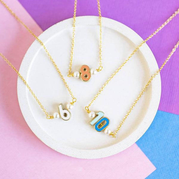 Image shows three Enamel Number Necklaces from left to right: 8, 6 and 10.