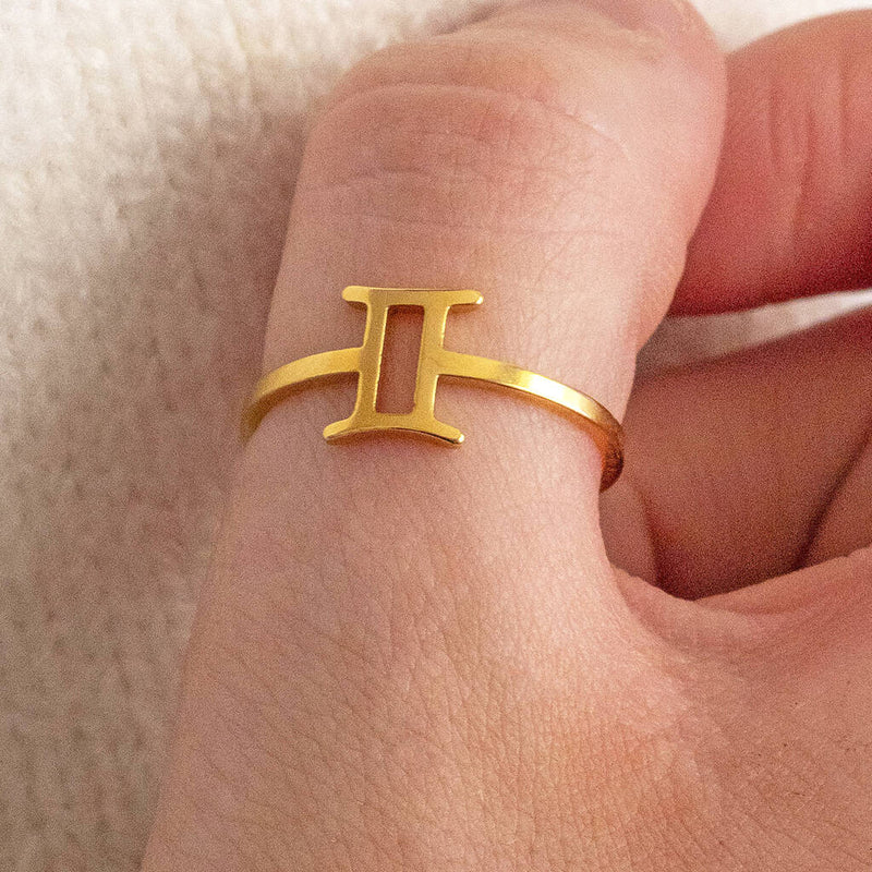 Image shows model wearing a gold plated zodiac finger ring
