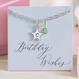 images shows a personalised silver star and birthstone charm bracelet on a card that reads birthday wishes