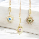 image shows three gold heart necklaces with birthstone charm detail on a white background