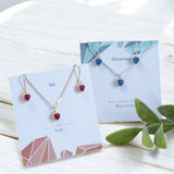 image shows July ruby and December blue zircon heart jewellery sets