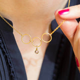 Image shows model wearing 30th birthday gold circles birthstone necklace