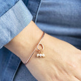 Image shows model wearing 30th birthday pearl charm bangle