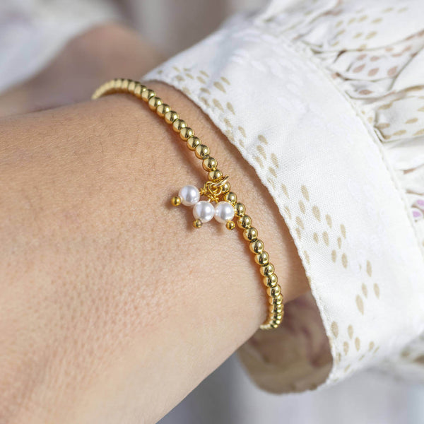 Image shows model wearing  gold 30th birthday pearl charm beaded bracelet