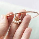 Image shows model holding rose gold 40th birthday pearl charm bracelet