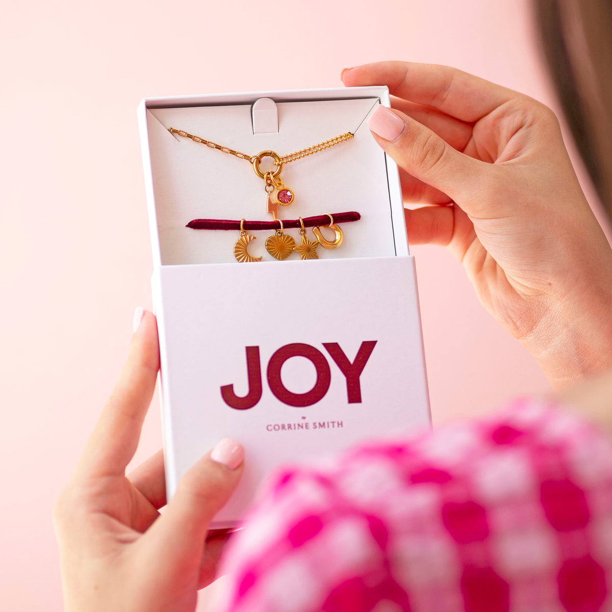 Personalised Week Of Charms Necklace in gold presented in JOY by Corrine Smith gift box with interchangeable moon, heart, star and horseshoe charms.