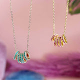 Image shows silver and gold 50th Birthday Birthstone Rings Necklace hanging side by side