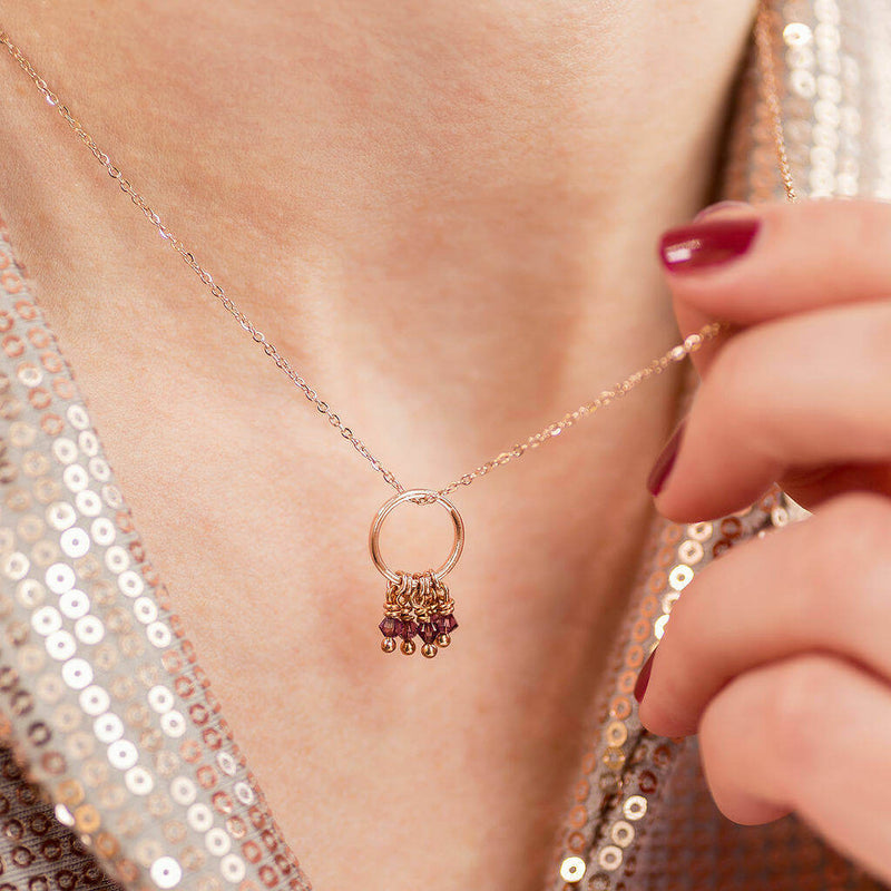 Images shows model wearing rose gold 50th birthday floating circle birthstone charm necklace