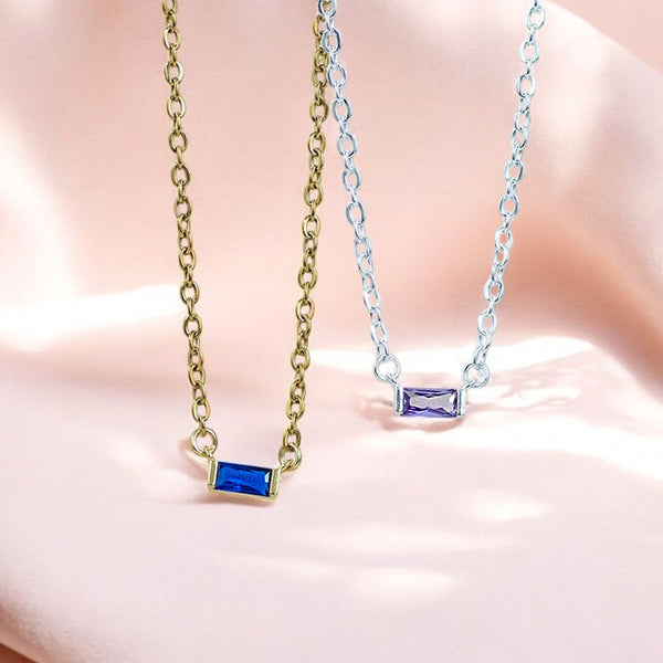 image shows a gold baguette birthstone necklace with sapphire stone and silver with amethyst stone