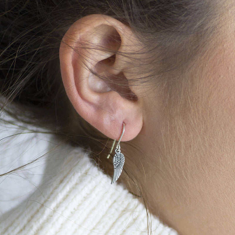 Image shows model wearing angel wing earrings 