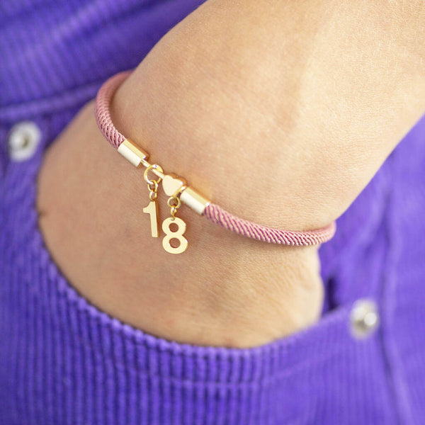 Image shows model wearing Any Age Birthday Bracelet with Heart or Star Detail