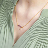 Image shows model wearing asymmetric birthstone bar initial necklace with July birthstone and J initial