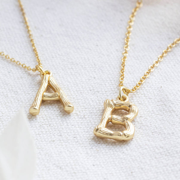 Image shows two bamboo style gold plated initial necklace