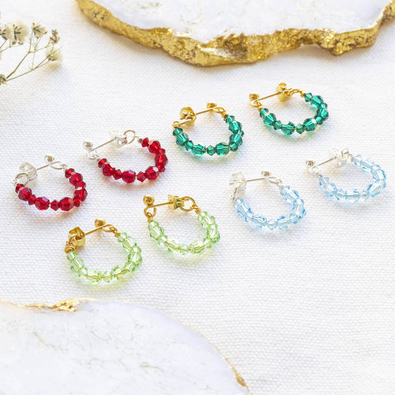Image shows a selection of Beaded Birthstone Huggie Earrings