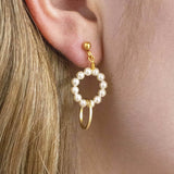 Model wears beaded pearl eternity earring