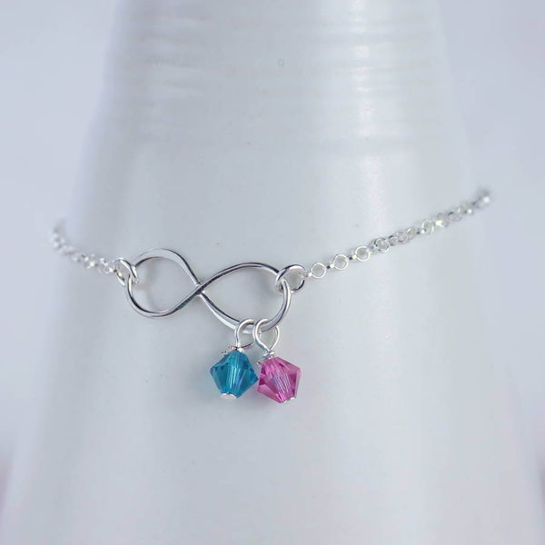 Best friend infinity birthstone charm bracelet with blue zircon and rose birthstone crystal round a white bracelet holder