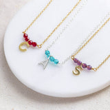 Image shows two gold and one silver birthstone bar necklace with initial charm