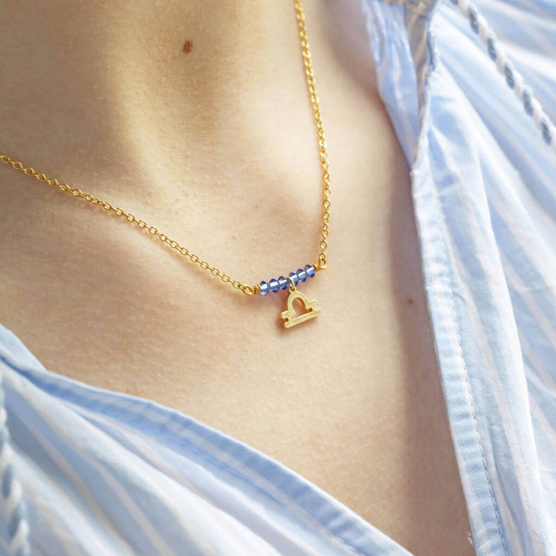 Image shows model wearing Birthstone Bar Necklace with Zodiac Charm Detail