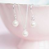 Bridesmaid Swarovski pearl jewellery gift set hanging from a pink bowl with gold rim