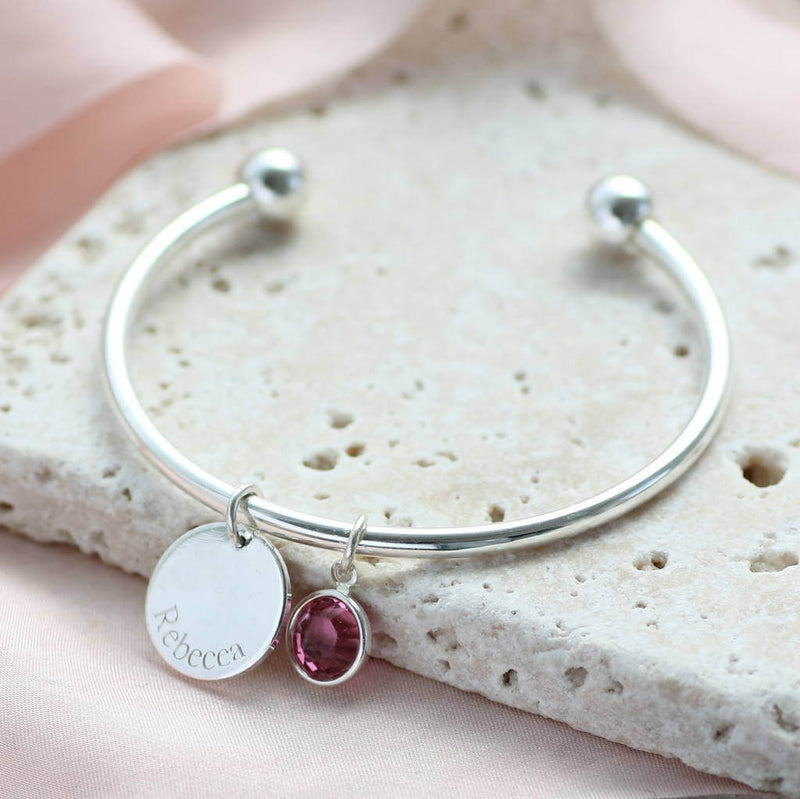 Child's Personalised Disc Birthstone Bangle with the name Rebecca engraved and February birthstone