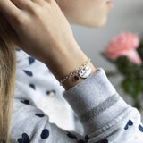 Image shows model wearing Childs personalised sister charm bracelet with middle sister charm and February birthstone