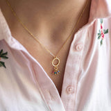 Image shows model wearing circle of life birthstone necklace