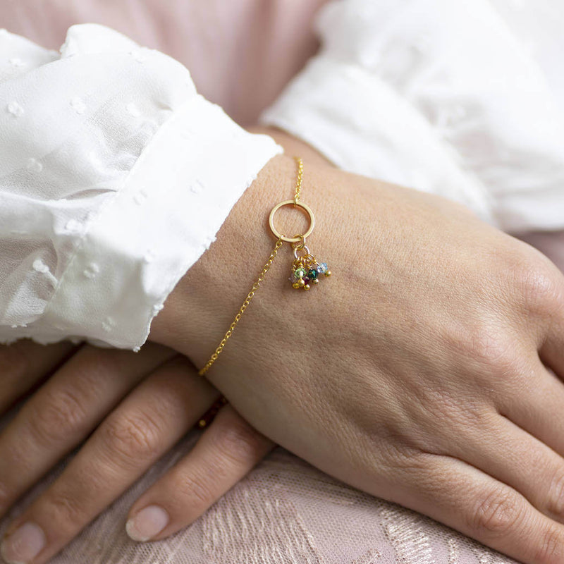 Image shows model wearing circle of life family birthstone charm bracelet
