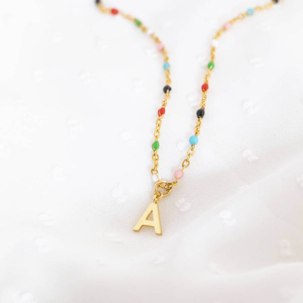 Image shows colourful beaded initial charm necklace with the initial A