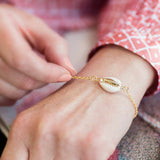 Image shows model wearing Cowrie Shell Bracelet
