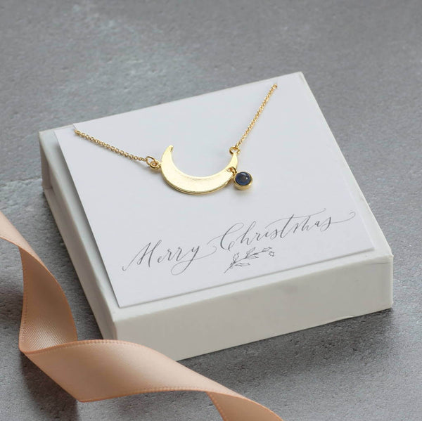 Image show Crescent Moon Necklace With Mood Stone on a merry Christmas sentiment card
