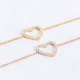 Image shows a gold and rose gold Crystal Outline Heart Bracelet