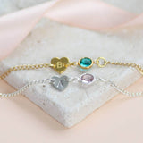 Image shows a gold and silver dainty heart bracelet with birthstone 