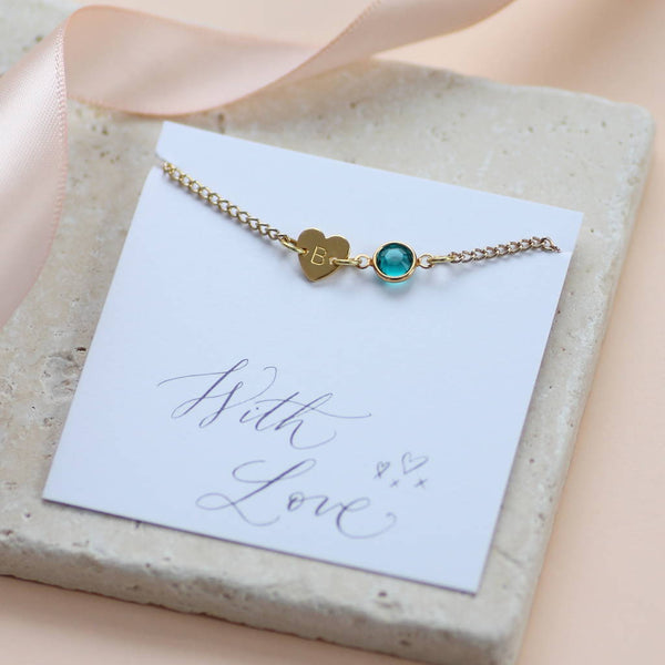 Image shows a gold dainty heart bracelet with birthstone  