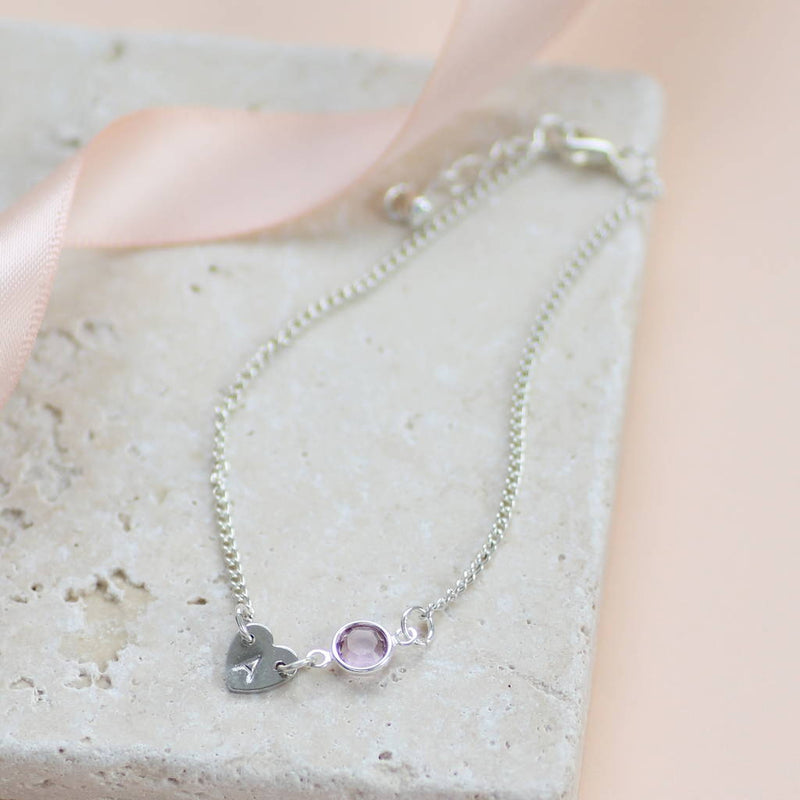 Image shows a silver dainty heart bracelet with birthstone  