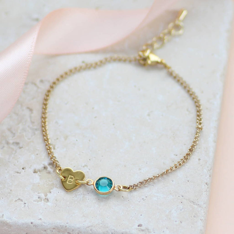 Images shows gold dainty heart bracelet with birthstone  