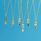 Image shows a selection of dainty leaf chain teardrop birthstone necklace