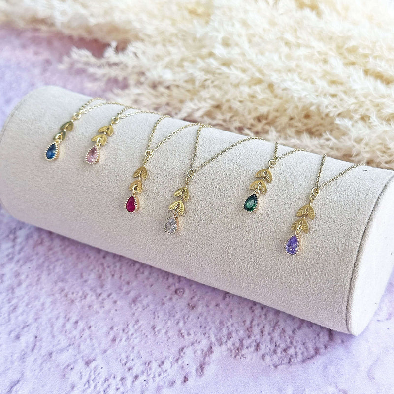 Image shows a selection of dainty leaf chain teardrop birthstone necklace