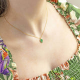 Image shows model wearing green Dainty Monstera Leaf Enamel Necklace
